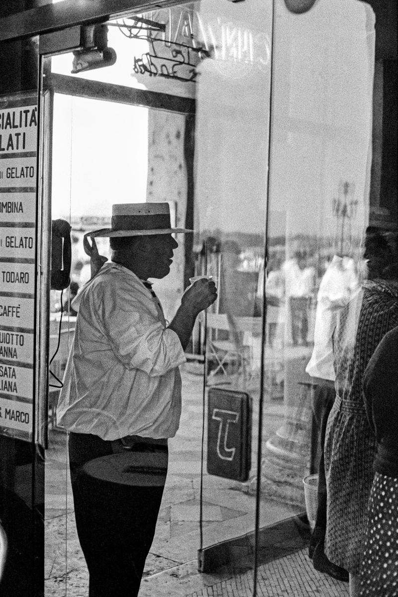 ITALY. Venice. Gondolier drinking coffee while having a break. 1964.