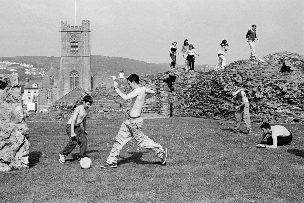GB. WALES. Aberystwyth. A spontaneous football match within the grounds of the derelict castle. 2000.