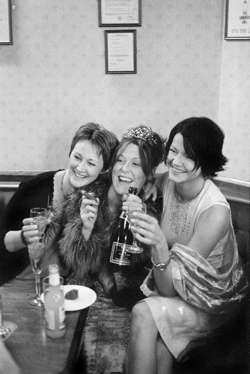 GB. WALES. Cardiff. Butetown - once know as &#039;Tiger Bay&#039;. The bride, Joanne, and two friends at her Wedding Reception in the Packet Pub, Bute Street, for Graham and Joanne Porter&#039;s Wedding. 2000