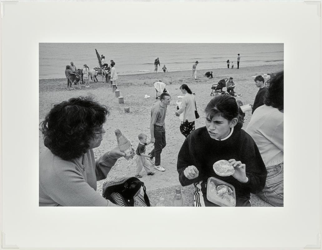 Family group. The promenade and sands. Rhyl, Wales