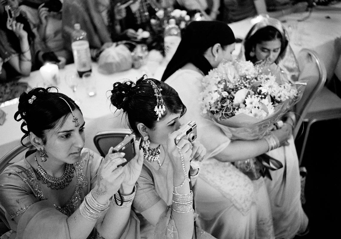 GB. WALES. Cardiff. Asian Wedding. Asian wedding in the City Hall in Cardiff. The aversion to being photographed is not prevelent in young modern Muslims. 2004.