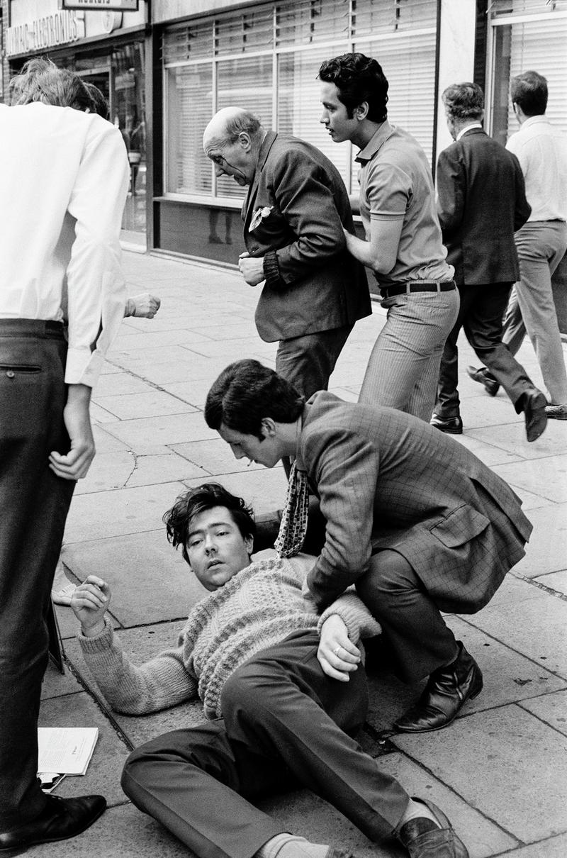 GB. ENGLAND. London. Queensway. Smash and grab raid on A B David jewellers and Silversmiths. Photographed when I was on my way to my ritual morning coffee. Published as a wrap around cover of the Sunday Mirror. 1969. (Image 6/8)