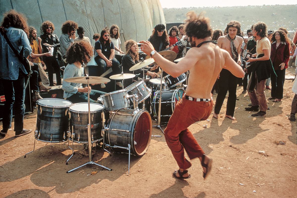 GB. ENGLAND. Isle of Wight Festival. The Pink Fairies, anarchist rock group, play for free to a bare chested dancer. 1969.