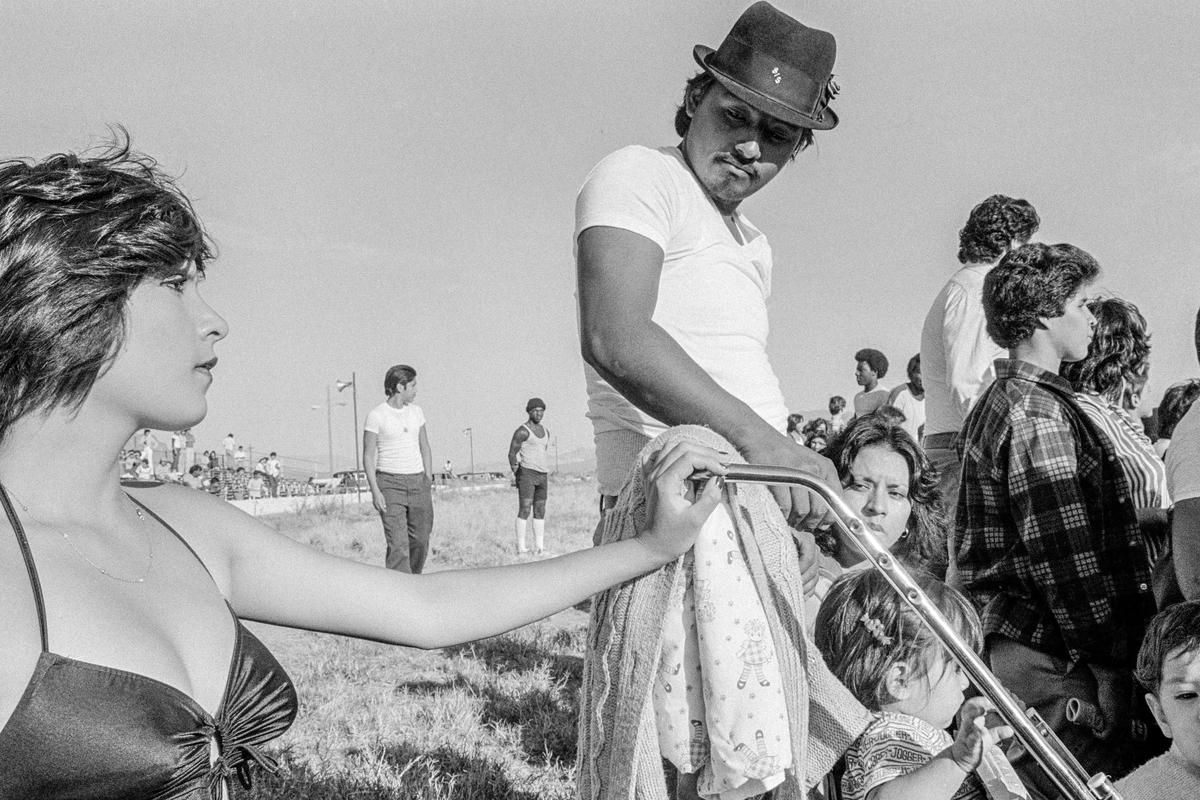 USA. ARIZONA. A young Chicano mother - or elder sister - flouts her beauty at a Low Riders meeting in Phoenix. 1979.