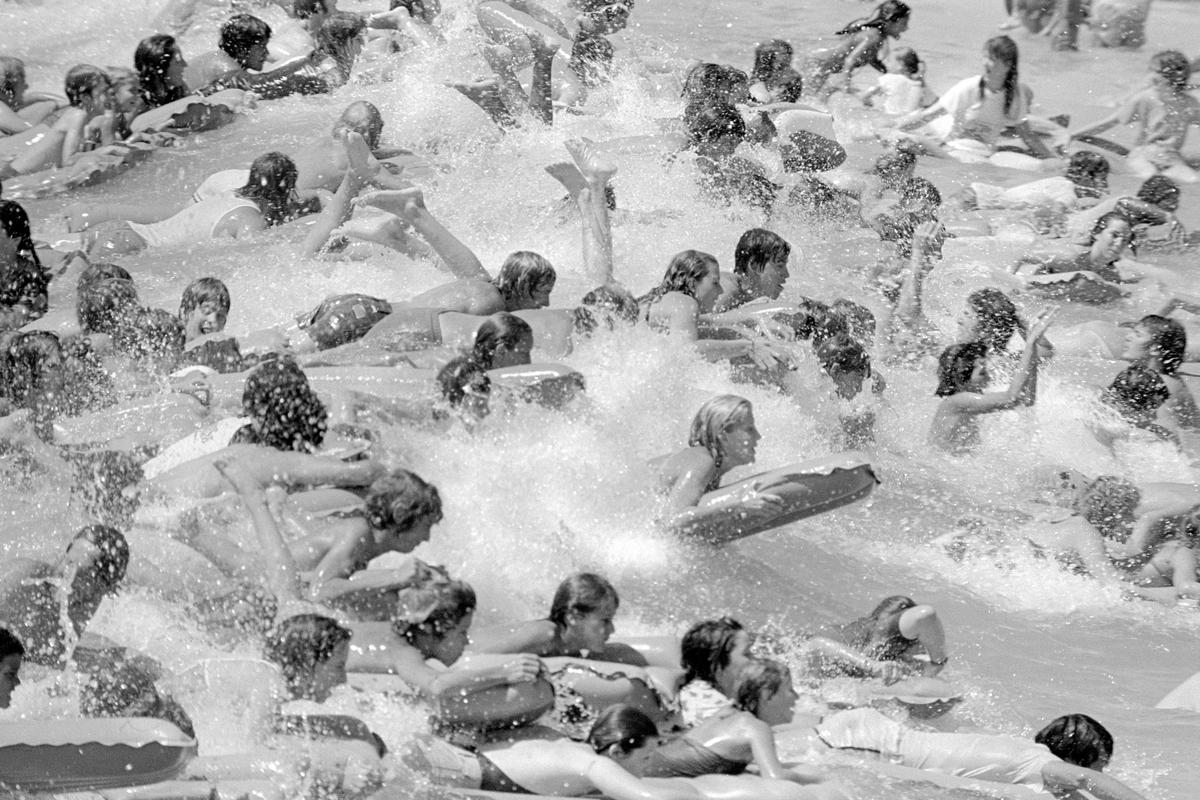 USA. ARIZONA. General.  Big Surf in the middle of the desert.  A large freshwater lagoon where you can ride rolling breakers up to five feet high, created by a hydraulic wave maker.  The waves roll onto a palm dotted, four acre, sandy beach. 1980.