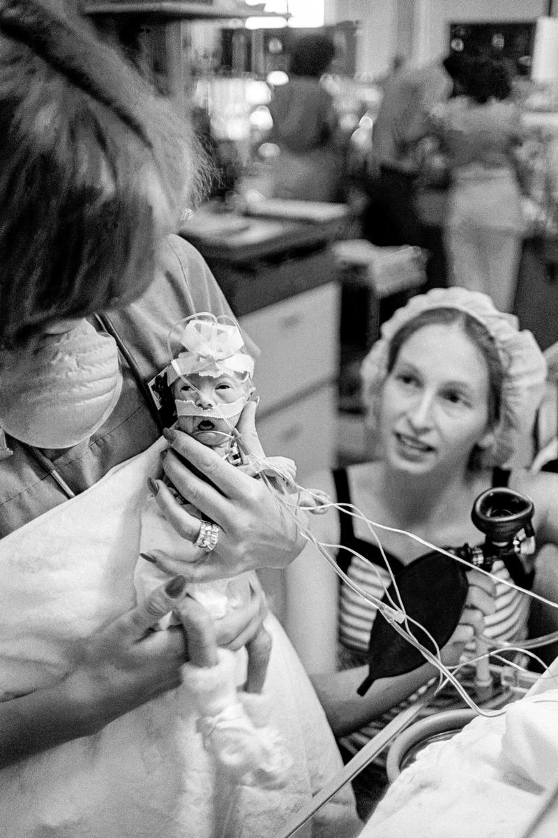 Preemie Baby unit at St Joseph&#039;s Hospital. Even at 1lb 14oz a baby can be picked up without breaking. The nurse shows how to the mother in the background.