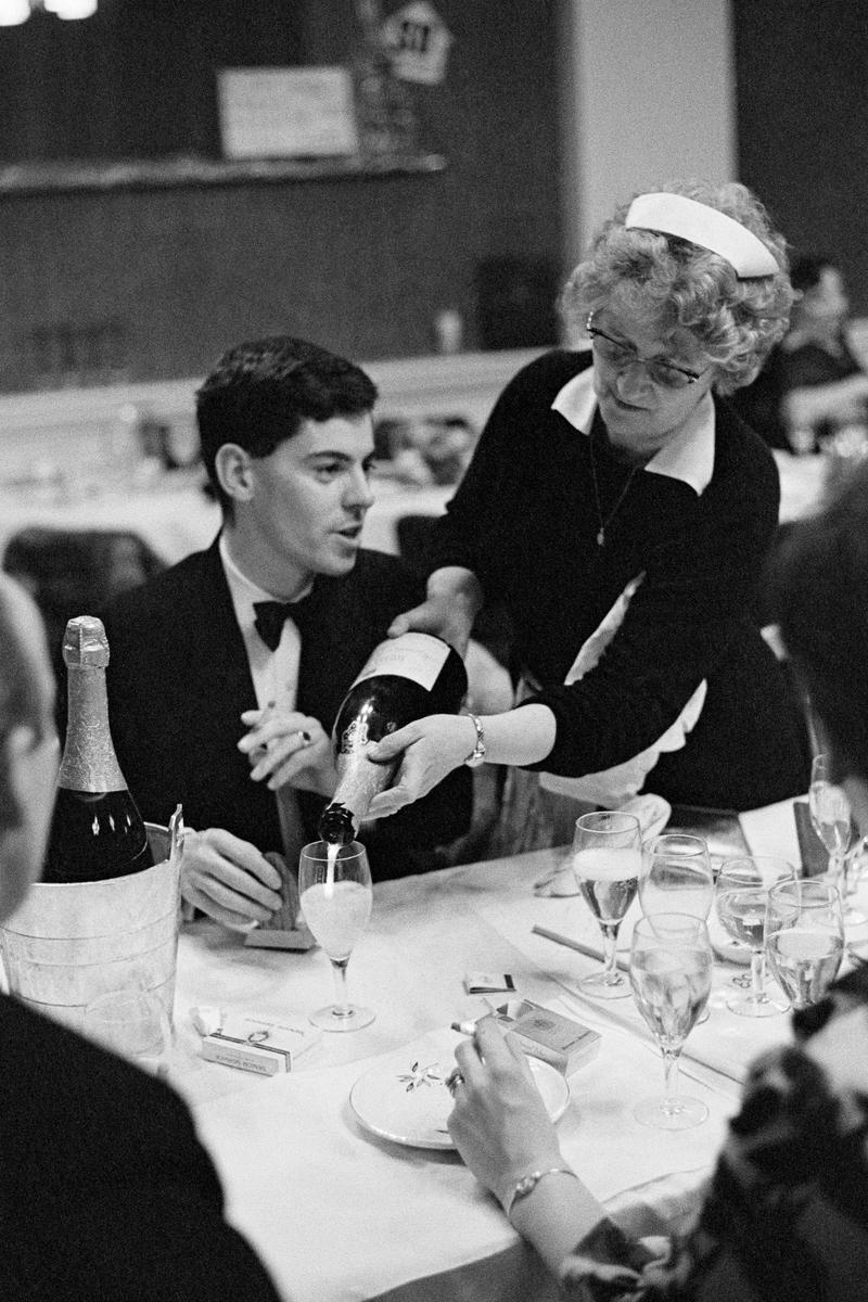 GB. SCOTLAND. Edinburgh. A waitress serves Champagne at a Hunt Ball. 1967.