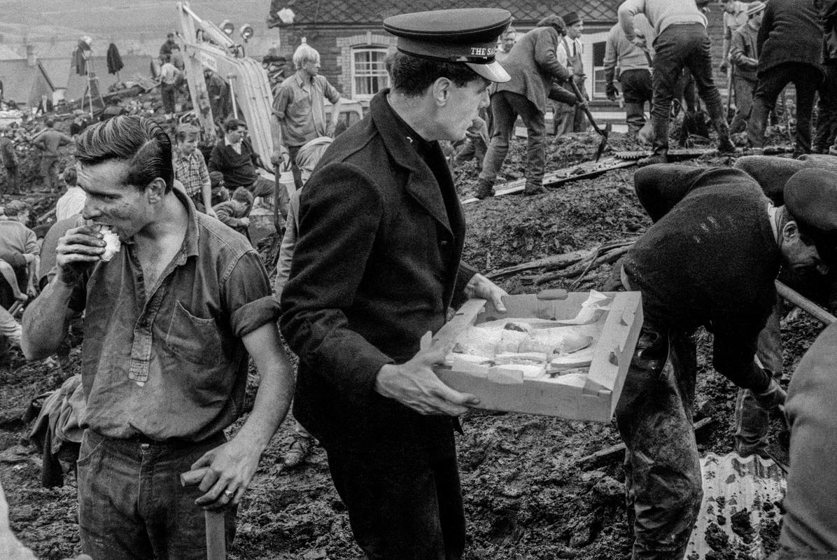 GB. WALES. Aberfan, The Aberfan disaster was a catastrophic collapse of a colliery spoil in the Welsh village of Aberfan, on 21st October 1966, killing 116 children and 28 adults. It was caused by a build-up of water in the accumulated rock and shale, which suddenly started to slide downhill in the form of slurry. The Salvation Army are on hand with food. 1966.