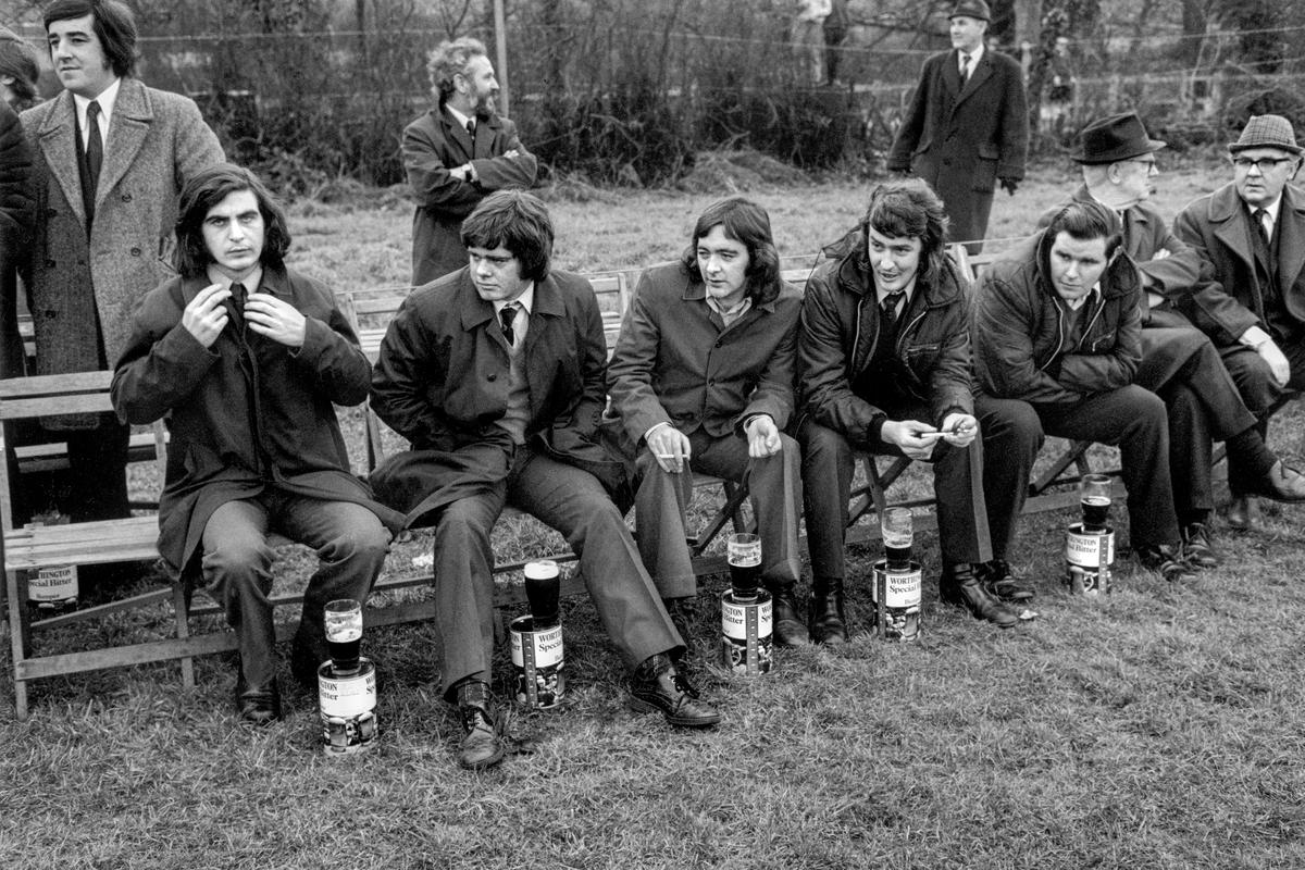 GB. WALES. Rhondda Valley. Spectators at an Old Boys rugby match. Beer seems an essential part of the whole macho experience. 1974