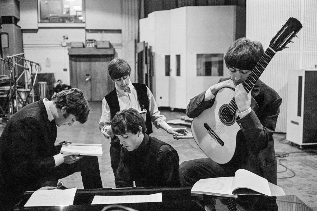 The BEATLES in the Abbey Road Studios, where many of their most famous records were made, examining the script of the film 'A Hard Days Night'. London, England