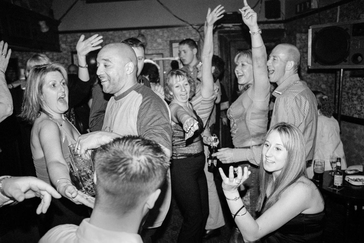 GB. WALES. Cardiff. Butetown - once know as &#039;Tiger Bay&#039;. Regulars in the Ship &amp; Pilot pub celebrating Michael Burrows Jnr&#039;s last night as Landlord. The pub is one of the oldest in the district. 2003.