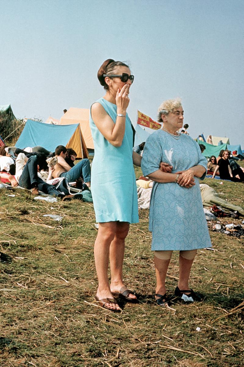 GB. ENGLAND. Isle of Wight Festival. Two Isle of Wight residents look out over the festival site. 1969.