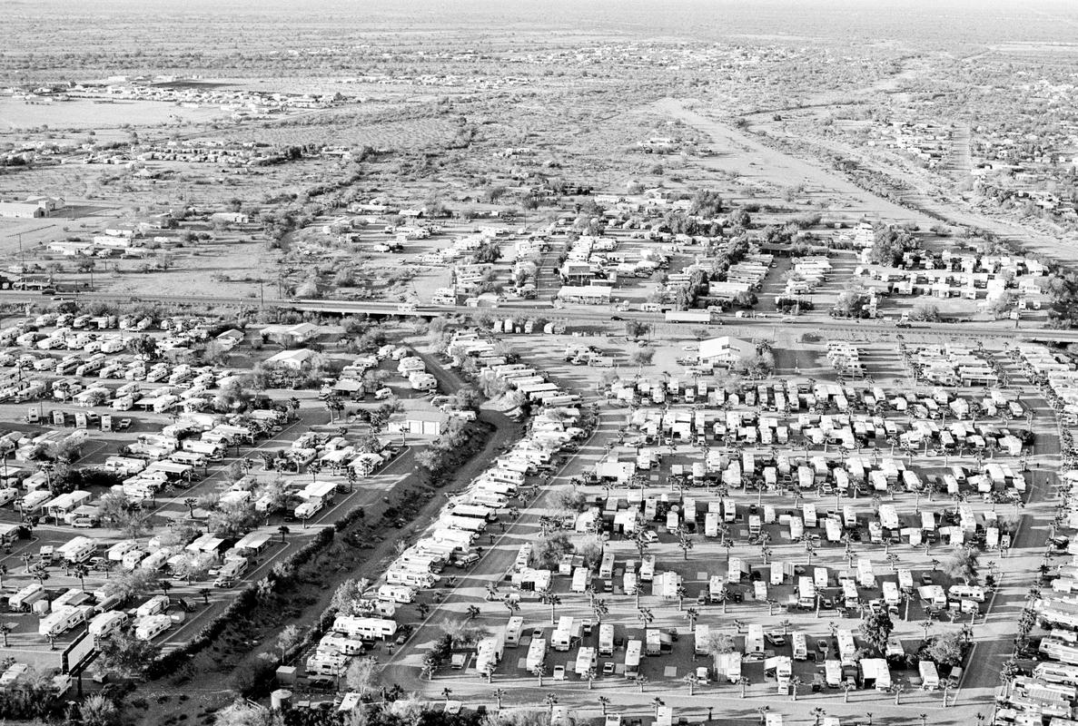 USA. ARIZONA. Quartzsite.  Quartzsite is a small town, population 2000, in Southwestern Arizona desert.  From October thru March the population increases to near the million mark.  The new visitors are called the &#039;Snowbirds&#039; coming from the cold north in their RVs.  Parking in the desert costs just $50 for the whole season. This picture shows the start of the arrivals. 1997.