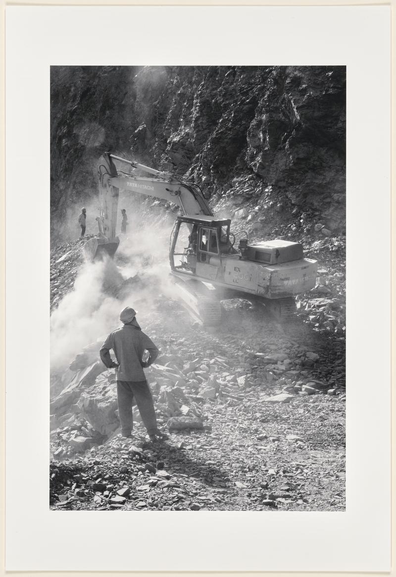 A Boarder Roads Organization (BRO) workers with heavy machinery try in vain to clear a recent landslide that blocked the road near Sumdo