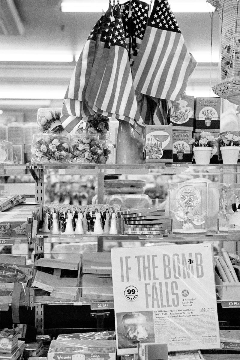 USA. NEW YORK. Lower Manhattan. Woolworth Shop &amp; Ban the Bomb record. Plus the American Flag. 1962.