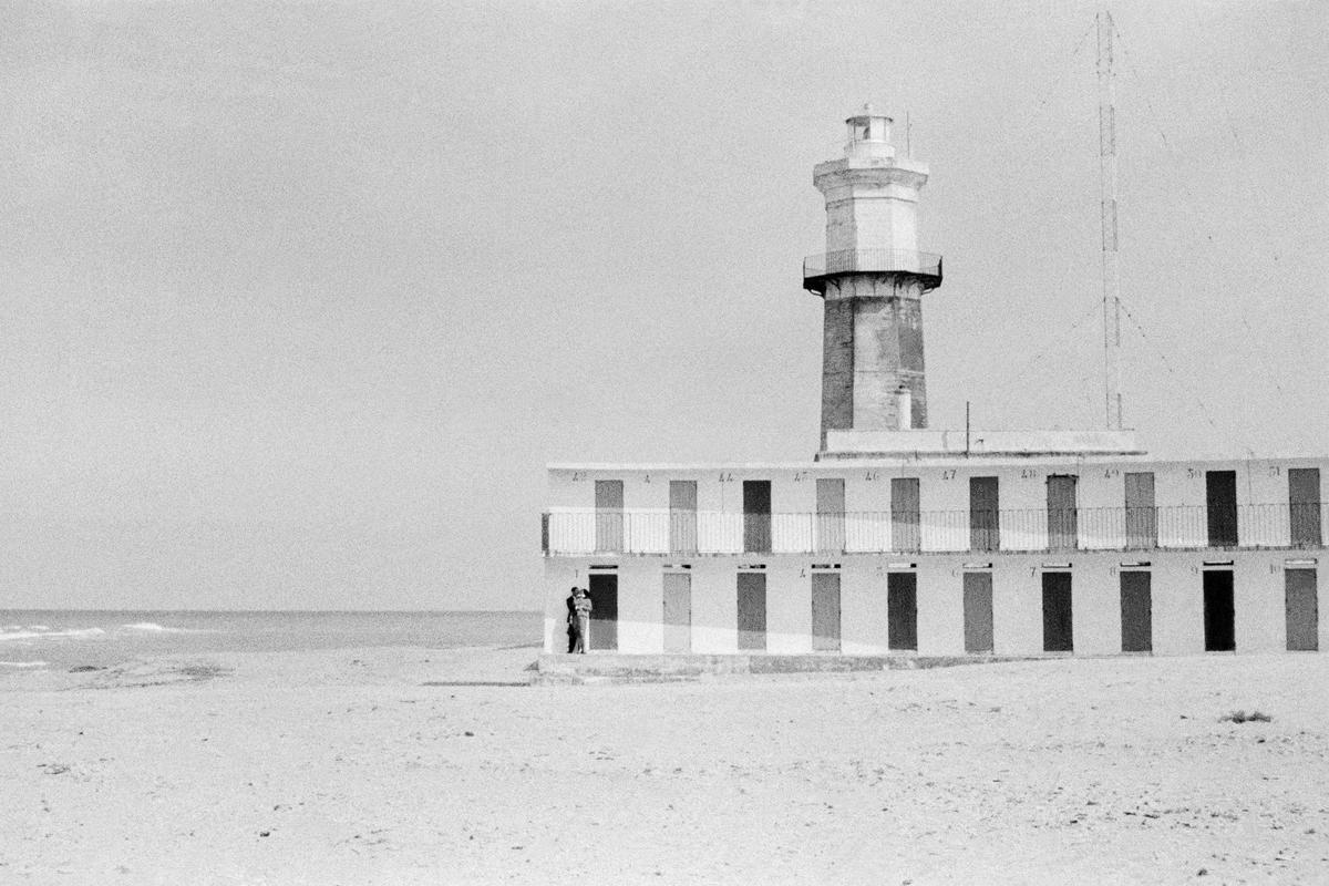 ITALY. San Cataldo. Lovers by the beach huts at the seaside in Cataldo. 1964.