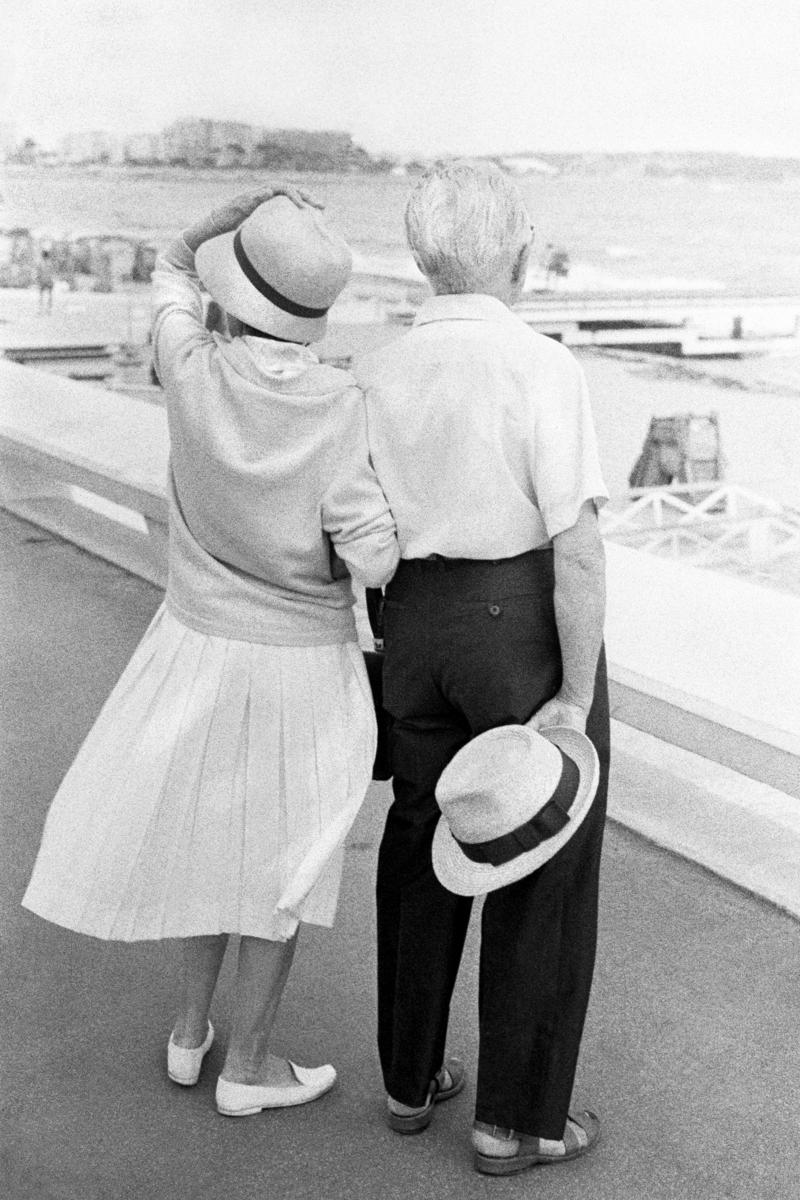 FRANCE. Cannes. Loving couple on windy day on the promenade at Cannes. 1964.