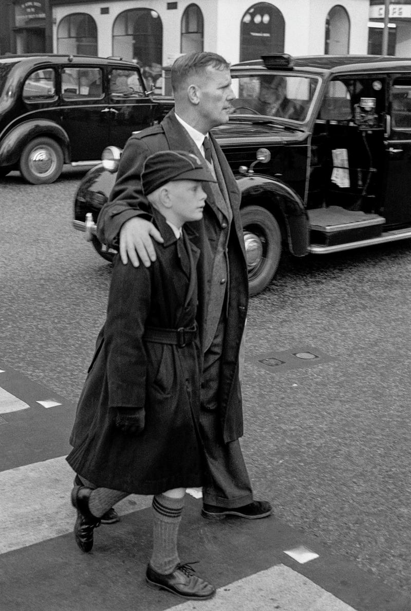 GB. ENGLAND. London. Soho. A father and schoolboy son walk in central London. Taken on a Contax 2 camera (first professional camera). 1958.