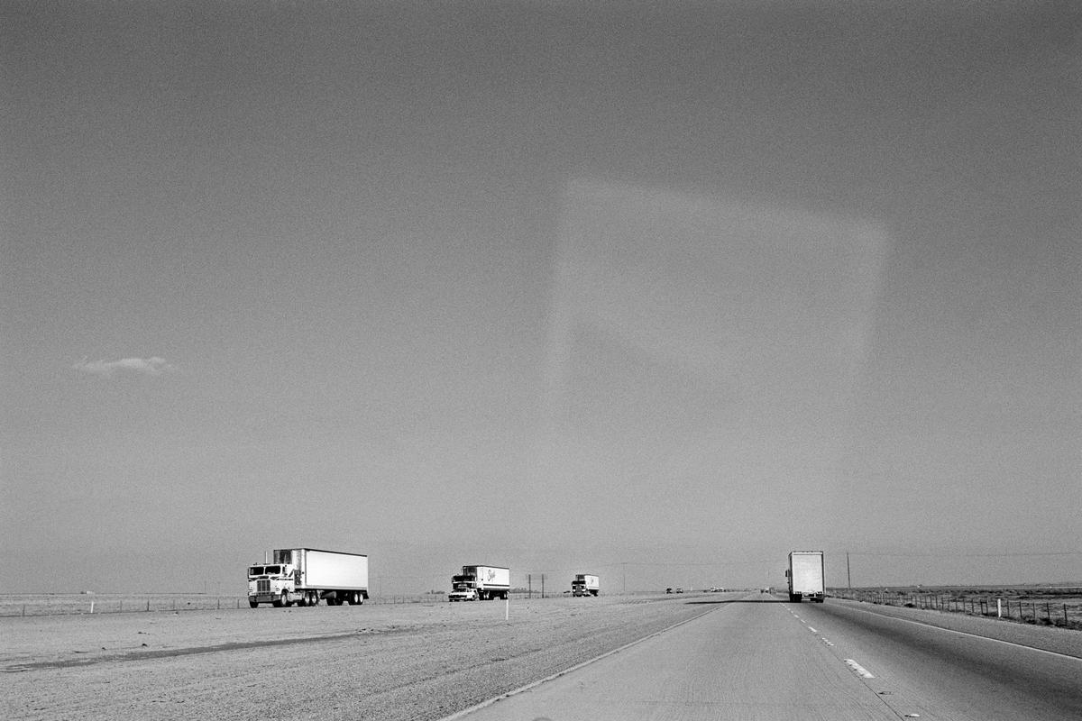 USA. CALIFORNIA. Route 48. The San Andreas Fault causes huge straight valleys and planes along which have been built mile upon mile of completely straight highway like an extended Roman road. 1991.