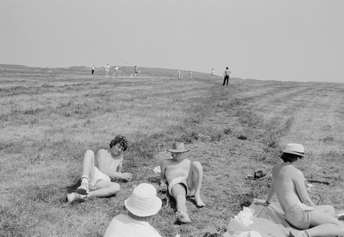 GB. WALES. Trelleck. Village cricket competition. The game is an excuse for a friends day out in the sun with picnics and perhaps a little drink. 1986.