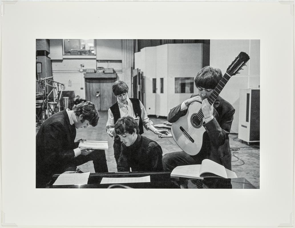 The BEATLES in the Abbey Road Studios, where many of their most famous records were made, examining the script of the film &#039;A Hard Days Night&#039;. London, England