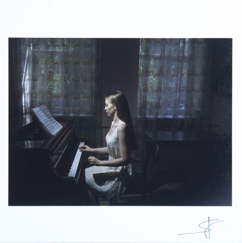 UKRAINE. Mariupol. June 2, 2015. A student plays piano for her teacher during a year-end review at the music college.