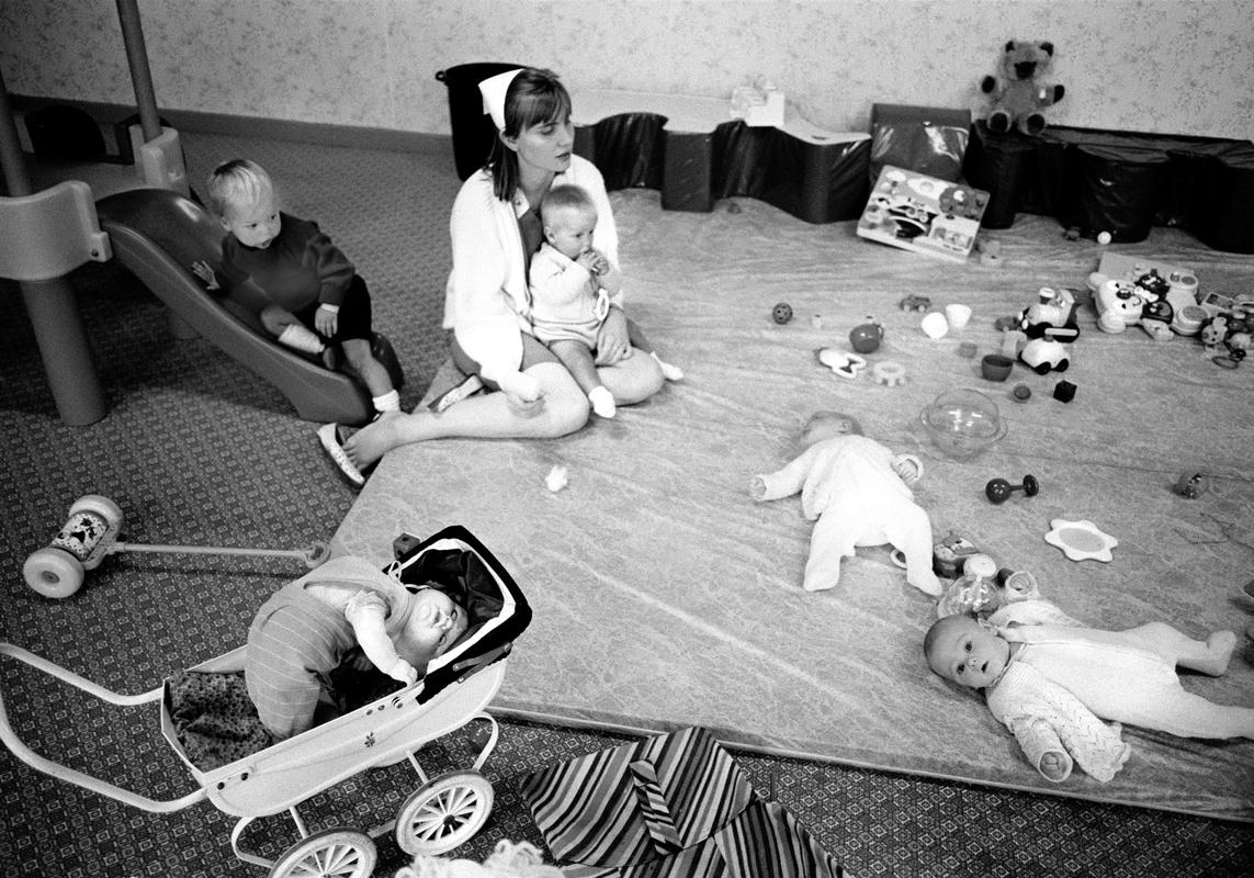 GB. WALES. Pwllheli. The very efficient baby care unit at Butlins Holiday Camp.  Part of the joy of the holiday for many of the parents is the chance of being able to leave their children for part of the day in the care of very well qualified and loving staff.  Pwllheli. 1986