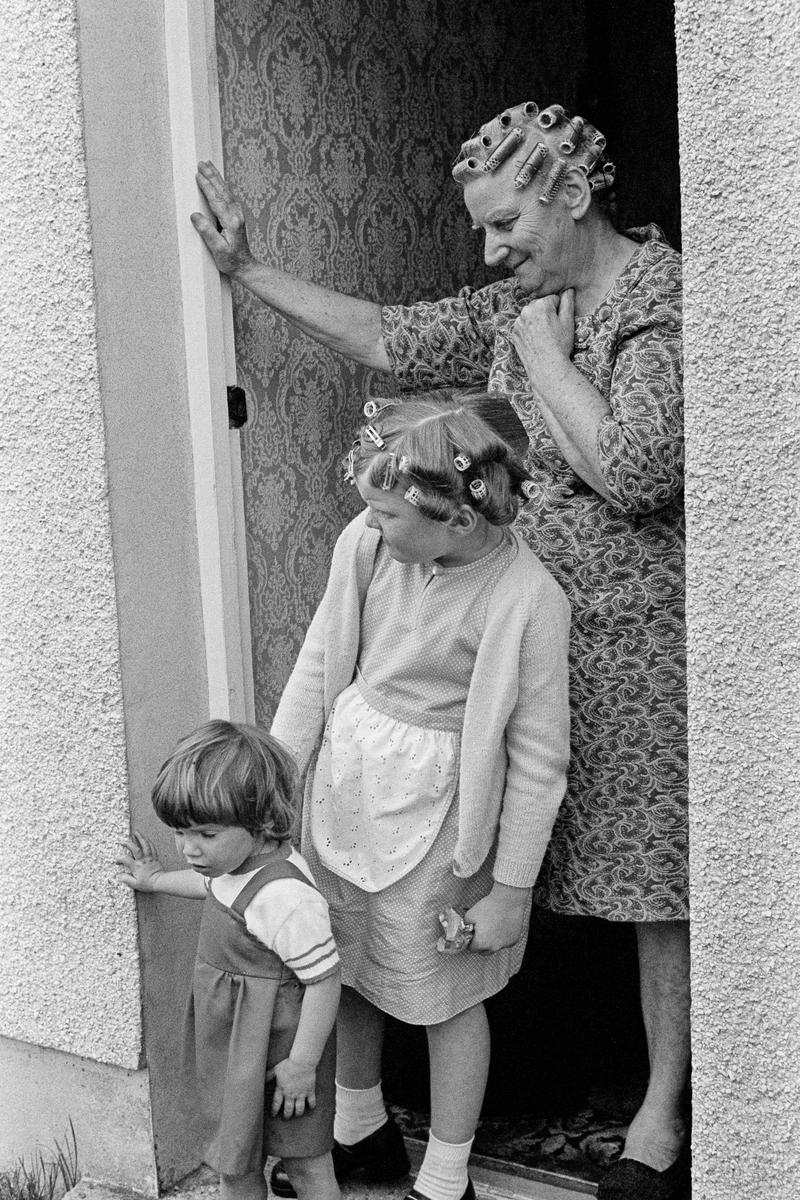 GB. WALES. Ammanford. Family at their front door. 1978.