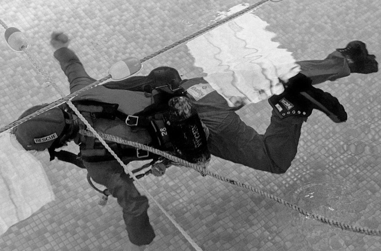 GB. WALES. Porth. The mine rescue team do hours practising underwater rescue apparatus before going underground to attempt a real rescue. 1979