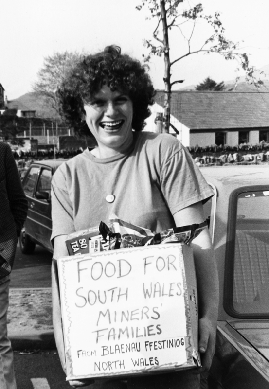 Woman holding a box marked 'Food for South Wales Miners' families'