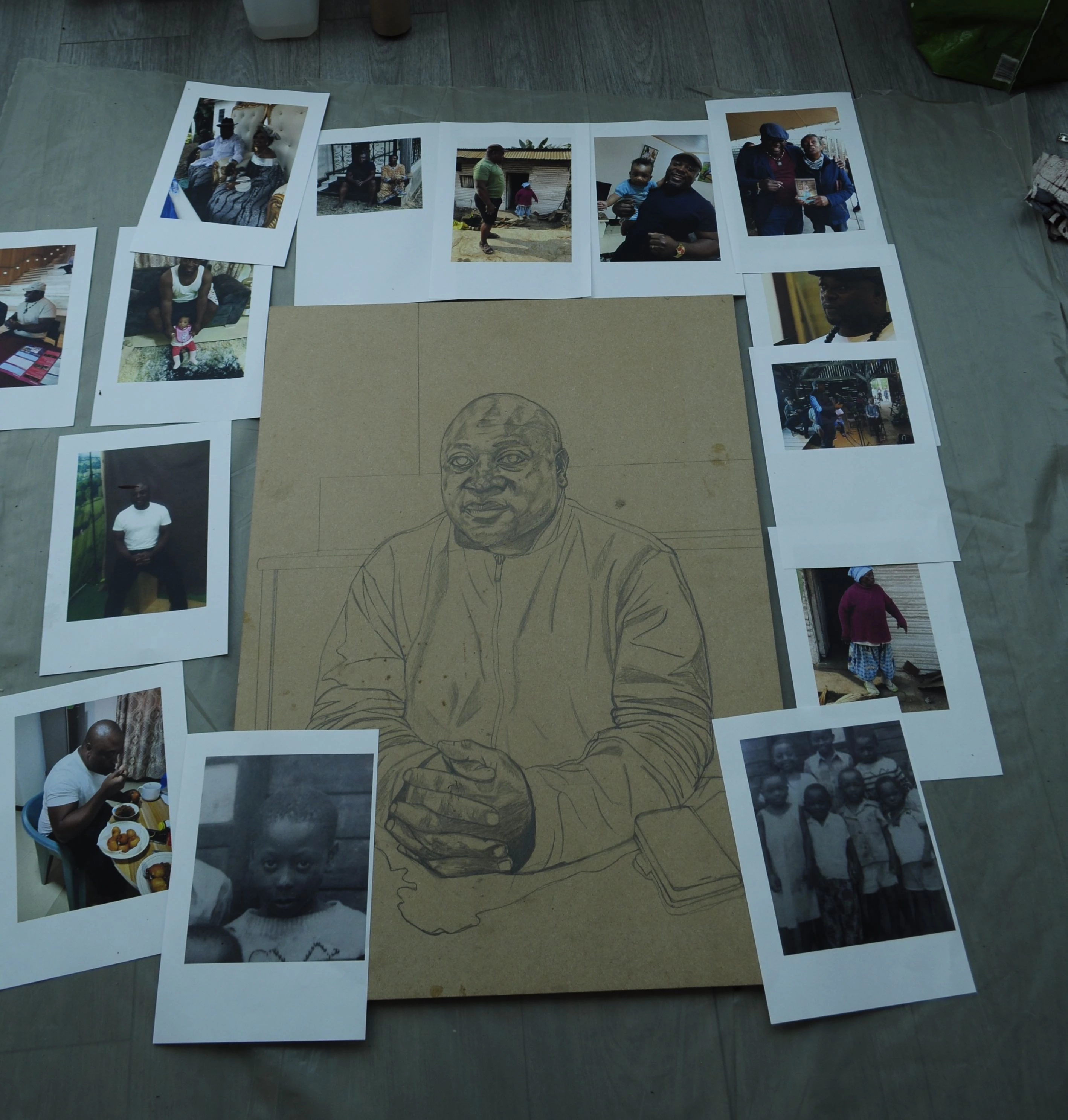 Sketch of a portrait of a man - pencil on paper - surrounded by polaroid photographs.
